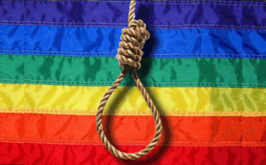 A noose with a pride flag backdrop.